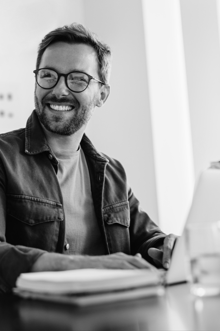 Smiling man using laptop