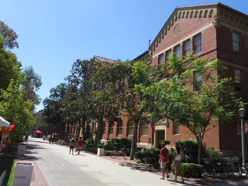Students walking past a campus building at the University of Southern California.