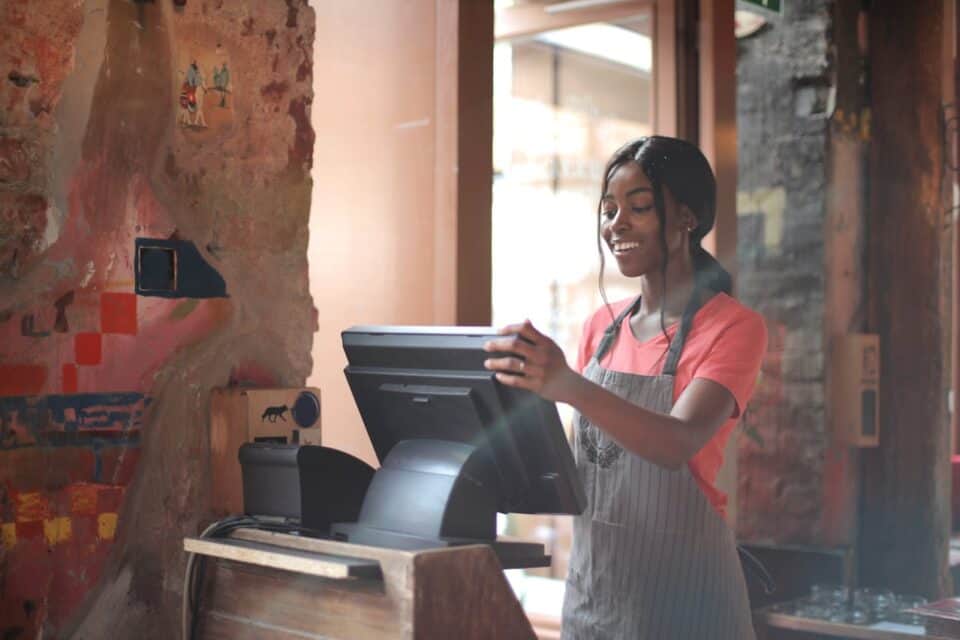 Female employee working on cash register.