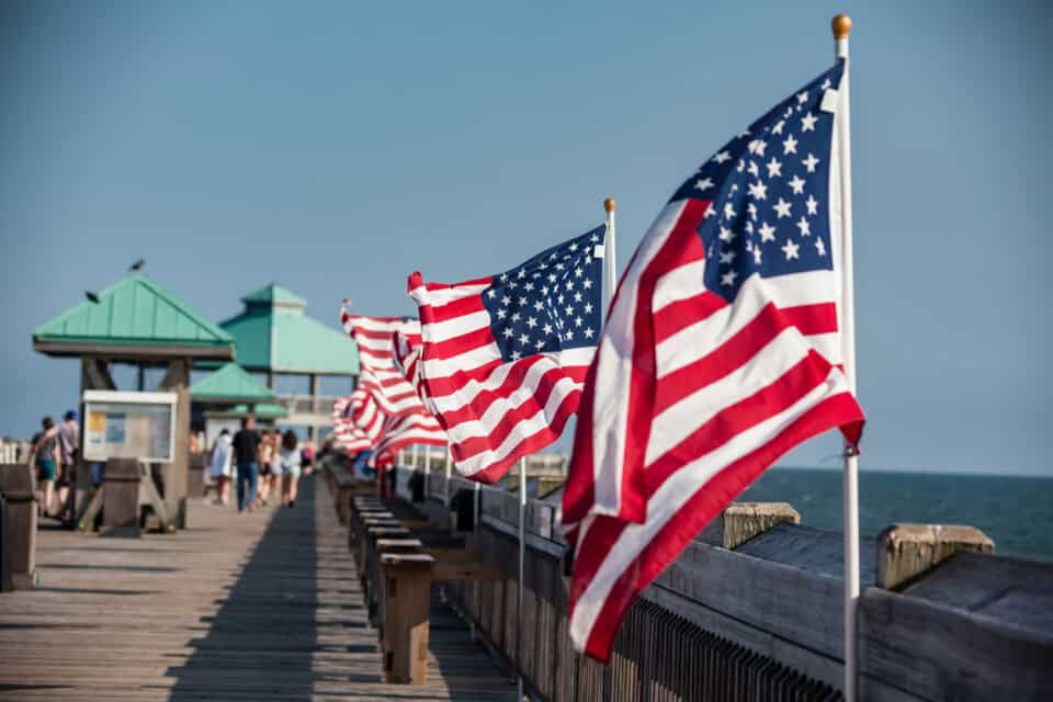 Line of American flags on pier.