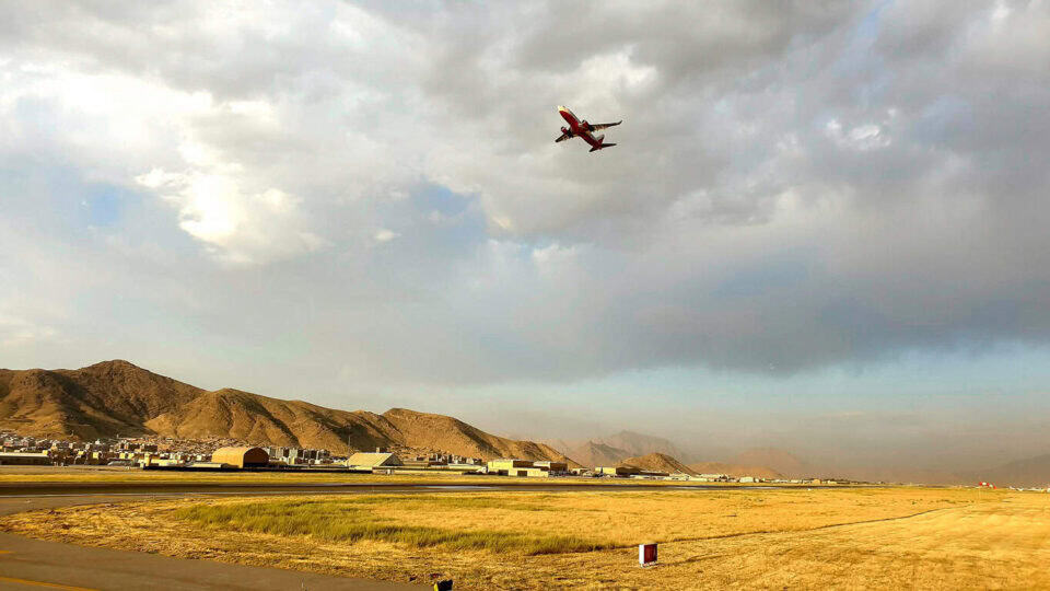 Plane flying over hills.
