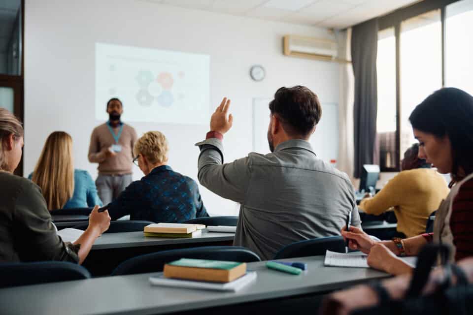 College students in classroom from behind.