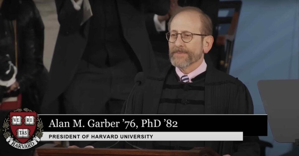 Harvard President stands on stage